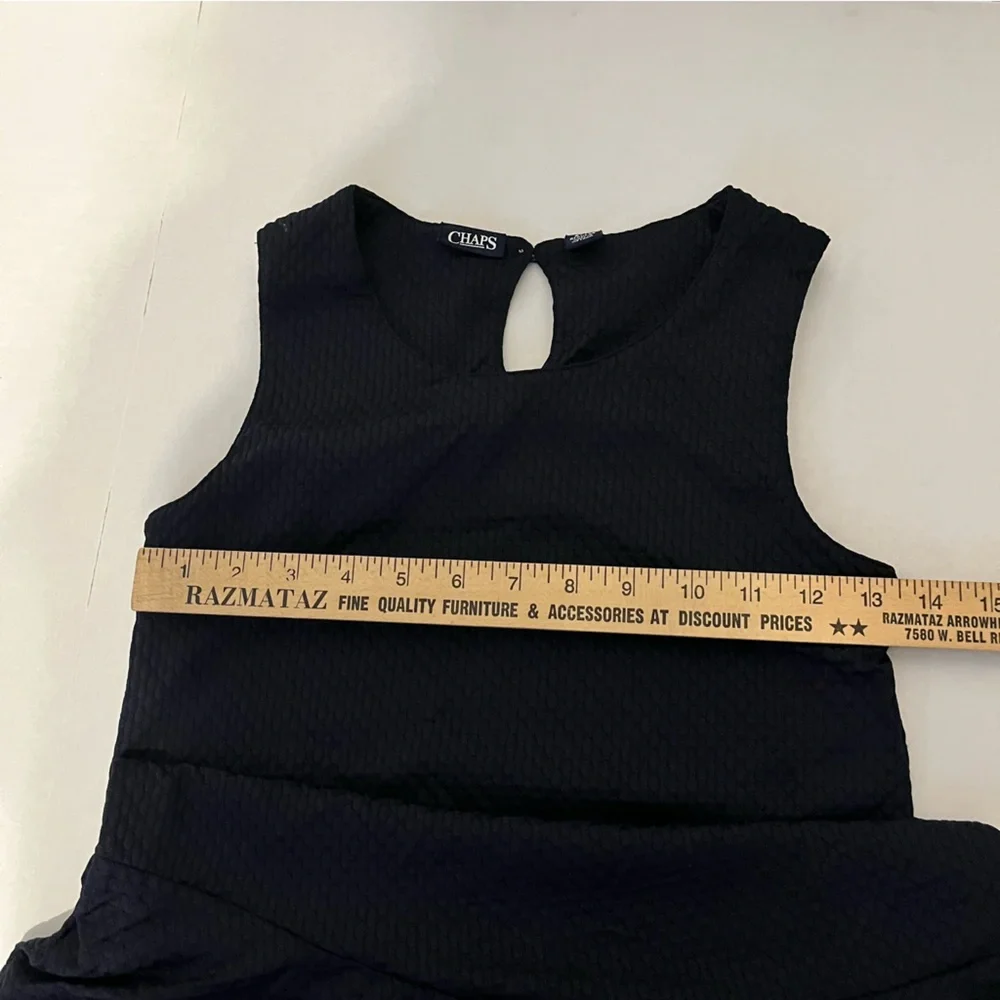 Chaps girls, navy blue jumper flounce hemline and a keyhole closure Size medium.